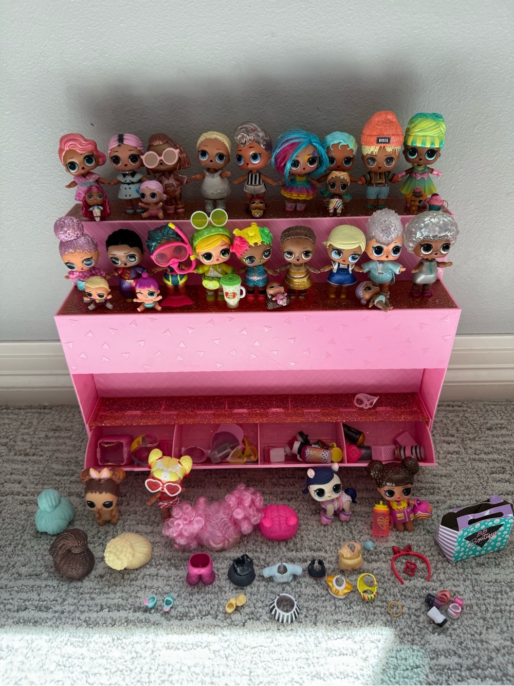 Pink Tiered Display of Assorted LOL Surprise Dolls and Accessories